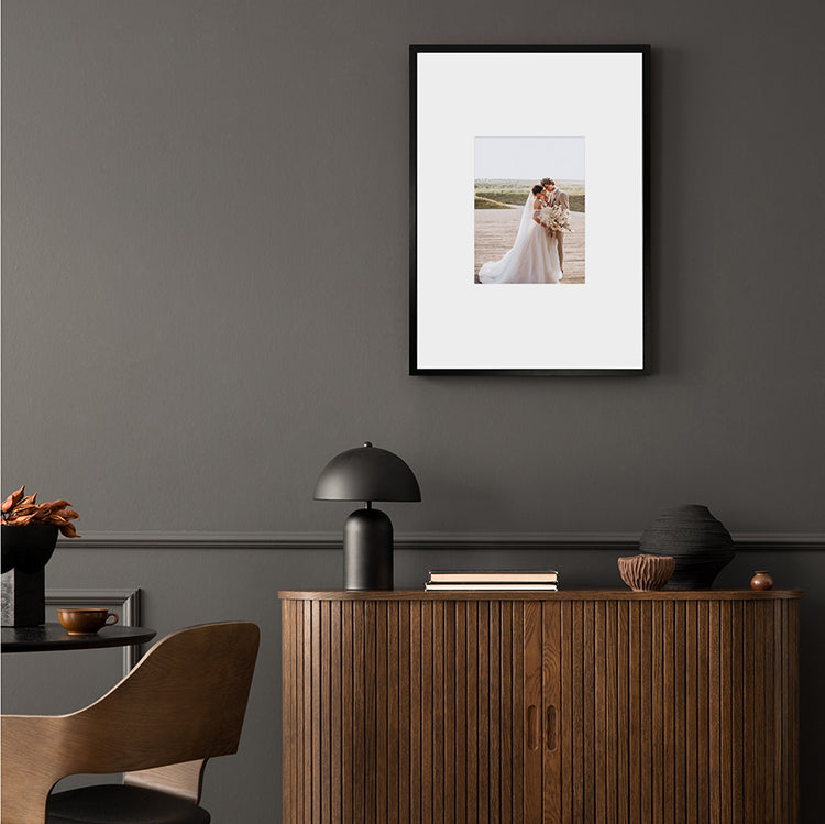 Mood Shot of Oversized Mount Wooden A2 Black Frame for 10x8 with a Photo of a Couple on their Wedding Day