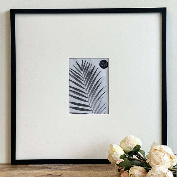 Oversized Mount Wooden 18x18 Black Frame for 7x5 with a Photo of a Plant and PF&A Logo
